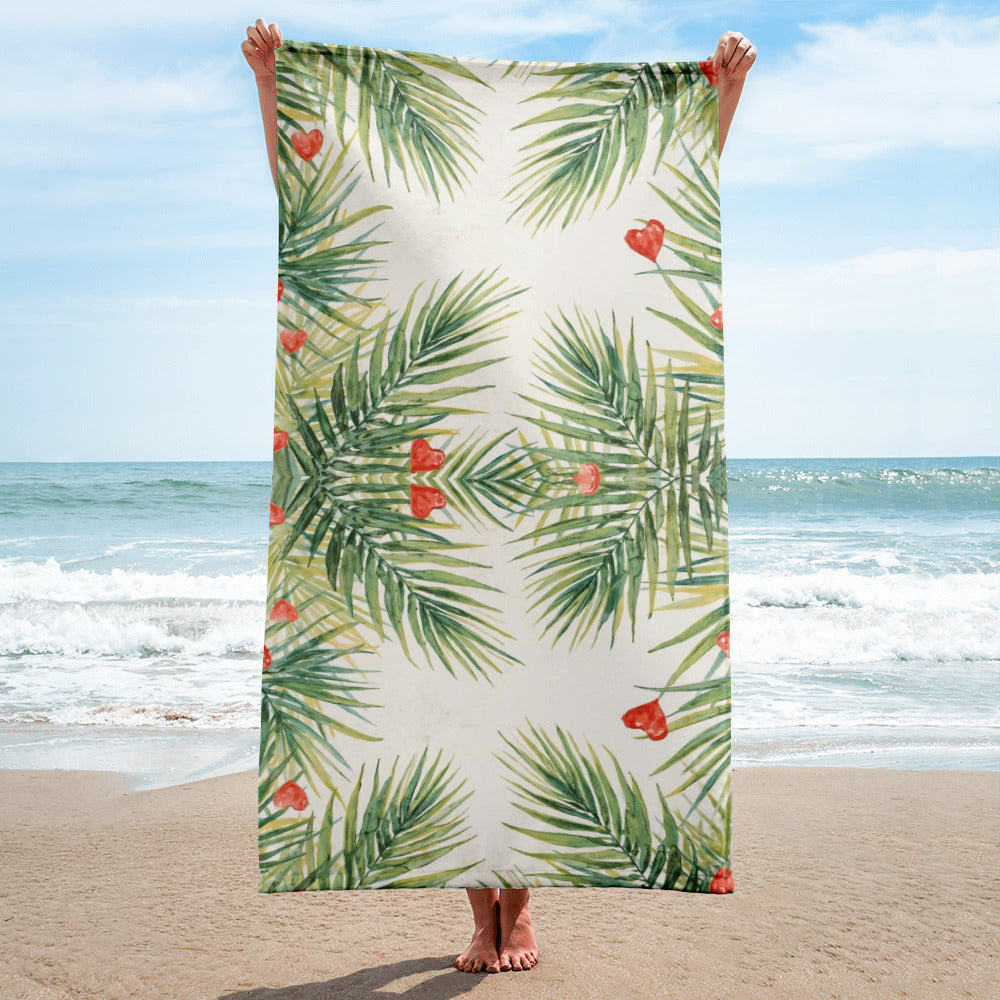 Tropical beach towel with palm leaves and red hearts pattern