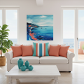Bright Italian coastal living room with striped square pillow and large coastal painting