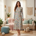 Confident woman in geometric pattern dress in cozy warm interior