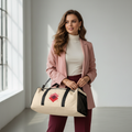 Elegant woman in burgundy trousers and pink blazer holding geometric squares duffle bag