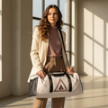 Elegant woman in taupe trousers and mauve turtleneck with geometric triangle duffle bag