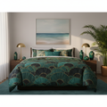 Emerald comforter with coastal artwork and plants