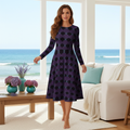 Woman in patterned midi dress by windows in coastal living room