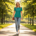 Woman wearing green printed t-shirt walking in sunny park